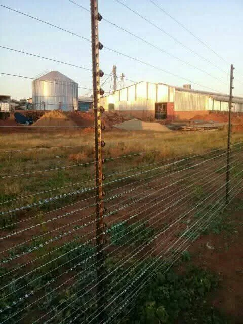 Cattle fence running across a rural farm field